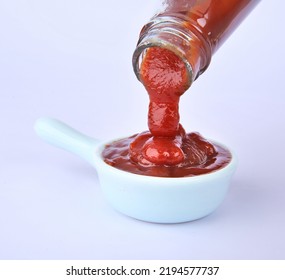 Red Tomato Ketchup Falling From White Bottle