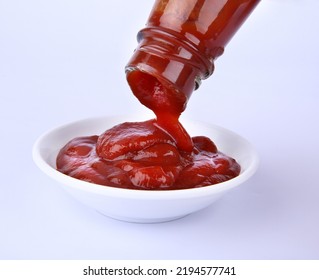 Red Tomato Ketchup Falling From White Bottle