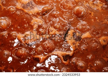 red tomato sauce bottom with spices cooking
