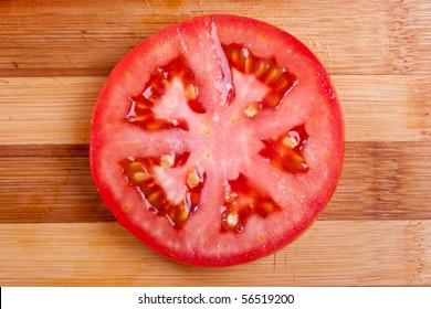 Red Tomato Slices On Chopping Board