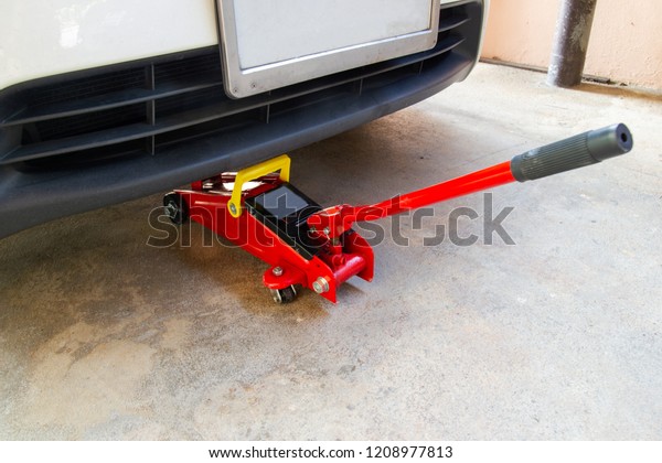 red tool jack lift car for repair check Maintenance of\
cars 
