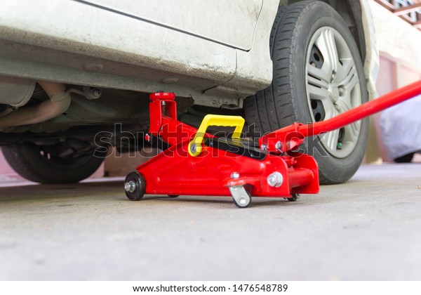 red tool jack lift car for Maintenance and\
service of cars at Car care\
maintenance\
