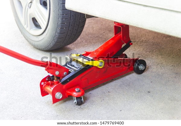 red tool jack lift car for Maintenance and\
service of cars at Car care\
maintenance\
