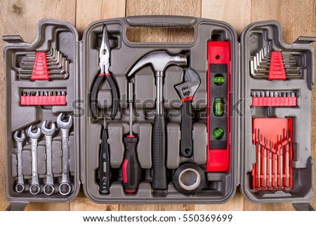Red tools and black toolbox on the shop (store) showcase. Many wrench and nuts in toolkit sets

