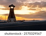 a red torii gate and a nightlight at the former ferry dock at maisaka port on lake hamana in hamamatsu city, shizuoka prefecture
