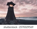 a red torii gate and a nightlight at the former ferry dock at maisaka port on lake hamana in hamamatsu city, shizuoka prefecture
