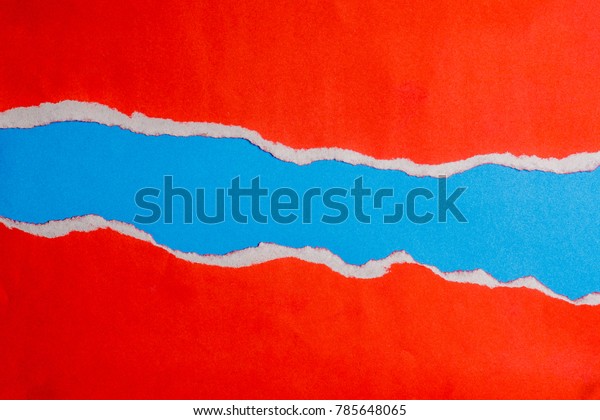 red torn paper with edges\
on blue paper and text copy space. Using idea design background or\
wallpaper.
