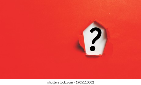 Red torn paper with question mark on white background. Question mark concept. 