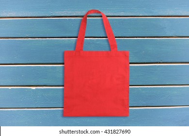 Red Tote Bag On Blue Wooden Background Or Texture