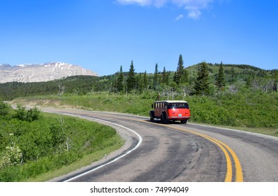 Red Tour Bus On Road In Scenic Glacier National Park