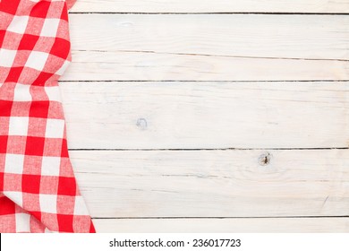 Red Towel Over Wooden Kitchen Table. View From Above With Copy Space