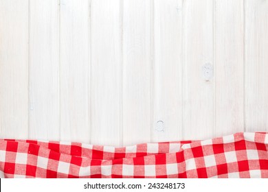 Red Towel Over Wooden Kitchen Table. View From Above With Copy Space