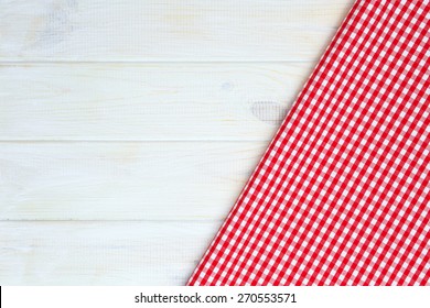 Red Towel Over Wooden Kitchen Table. View From Above With Copy Space