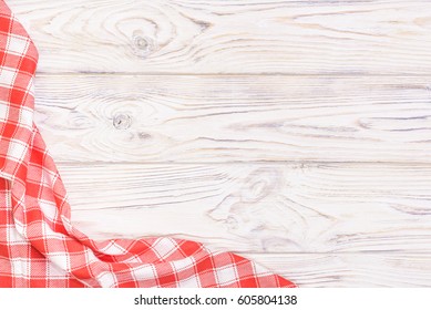 Red Towel Over Wooden Kitchen Table. View From Above With Copy Space.