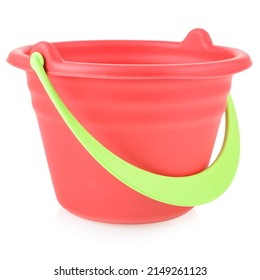 Red toy bucket made of plastic or rubber, close-up, isolate on a white background. Children's toys for playing in the sandbox or on the beach. Development of fine motor skills of the child. - Powered by Shutterstock