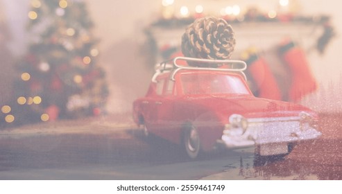 Red toy car carrying pine cone on roof, parking near Christmas tree. Soft lights and decorations adding warmth to holiday atmosphere - Powered by Shutterstock