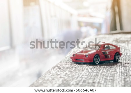 Red toy car with sunlight