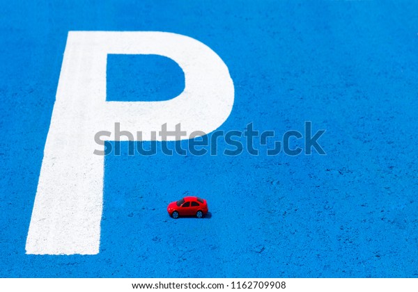 Red toy car and traffic sign \