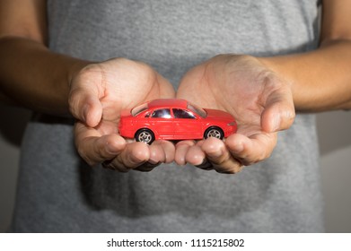 Red toy car in woman hand. - Shutterstock ID 1115215802