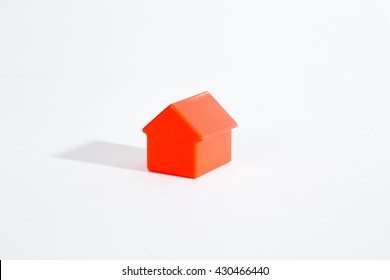 Red toy houses on white background