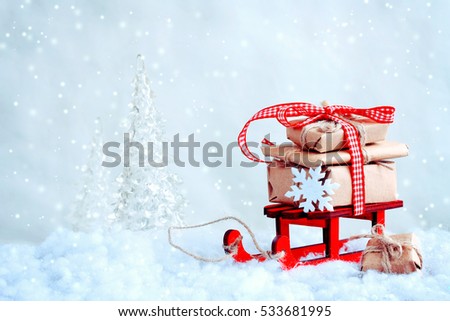 red toy sled with a pile of gifts, christmas tree, snow, retro style background
