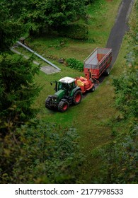 Red Tractor Carry Empty Trailer In The Woods.