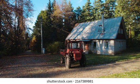 Red Tractor. Forest. Old Red Tractor Near To Hunter House In Forest. Farmer House. Forester. Home Of A Forester