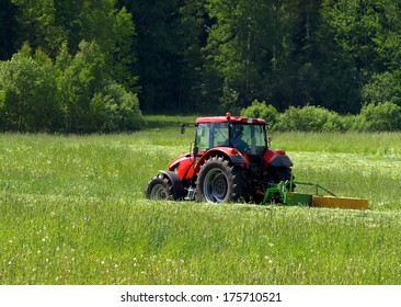 Red Tractor On A Green Field