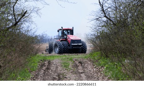 Red Tractor With A Plow On An Agricultural Field. Soil Preparation. Work With A Big Red Tractor. Field Work Concept. Harvesting, Farming. August 2020 Ukraine, Kiev Region, Editorial