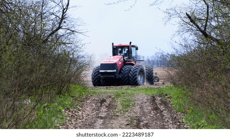 Red Tractor With A Plow On An Agricultural Field. Soil Preparation. Work With A Big Red Tractor. Field Work Concept. Harvesting, Farming. August 2020 Ukraine, Kiev Region, Editorial