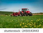 Red Tractor with Seeder in Lush Green Field