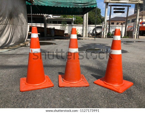 red\
traffic cones on the road and construction\
field