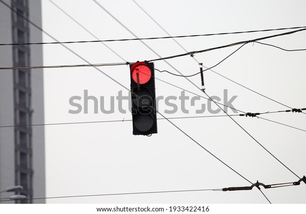 red traffic light\
among electrical wires