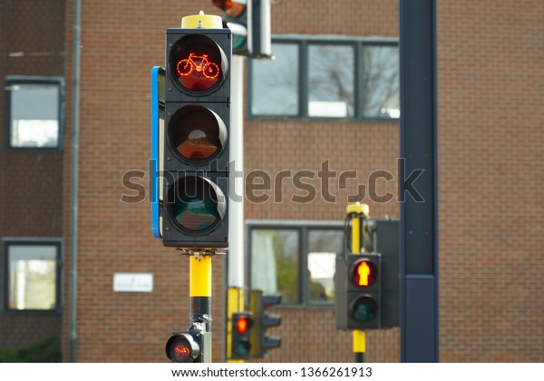 Red traffic light for bicycles. Red light for bikes,\
traffic orientation in European city. Don\'t cross the street\
sign