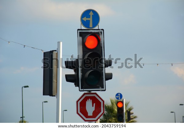 Red traffic light\
and Go straight or left and Stop signs. Mandatory and Prohibitory\
signs. Road signs in Israel