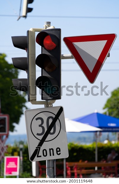 Red traffic light at grade crossing at City of\
Bregenz on a sunny summer day. Photo taken August 14th, 2021,\
Bregenz, Austria.