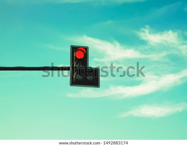 A red traffic\
light means to stop the car.