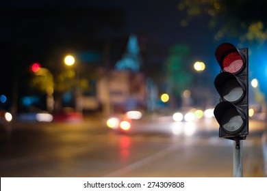 Red Traffic Light On The Road In Night City. Dangerous Signal Stop Crash Driving Highway,expressway; Blurred Background Of Car Dark Fast Truck Surveillance Security With Semaphore. Safety Street