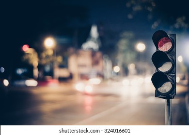 Red Traffic Light On The Road In Night City. Dangerous Signal Stop Crash Driving Highway,expressway; Blurred Background Of Car Dark Fast Truck Surveillance Security With Semaphore. Safety Street
