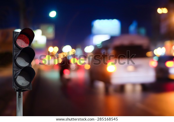 Red traffic light on
the road in night city. dangerous signal stop crash driving
highway,expressway. Blurred background of car dark fast truck
surveillance security.