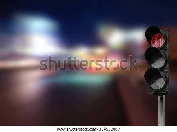 Red traffic light on\
the road in night city. dangerous signal stop crash driving\
highway,expressway. Blurred background of car dark fast truck\
surveillance security.
