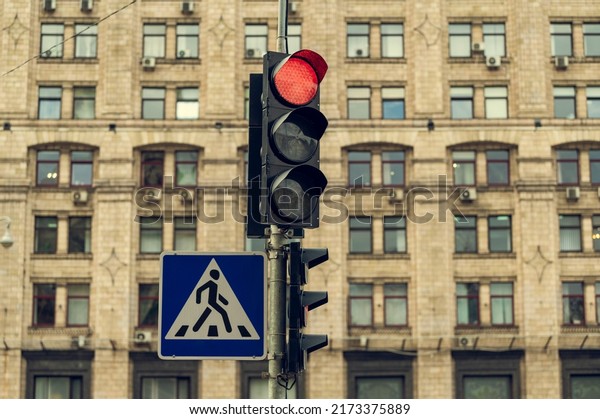 Red traffic light on, traffic stop and\
movement of vehicles and\
pedestrians