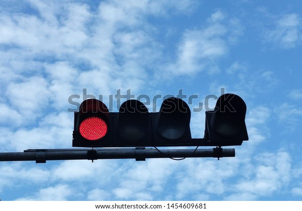 red traffic light\
signal with blue sky