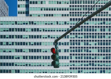 Red traffic light with windows in the background  - Powered by Shutterstock