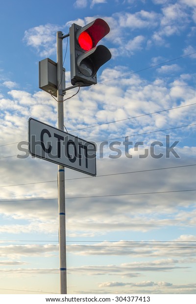 Red traffic\
stop sign against cloudy blue\
sky