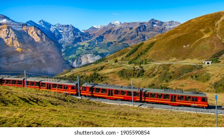 Red Train Is Climbing To Jungfraujoch. Switzerland. 