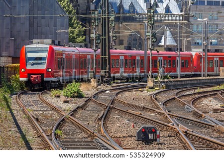 red train depart from the station Cologne Germany.