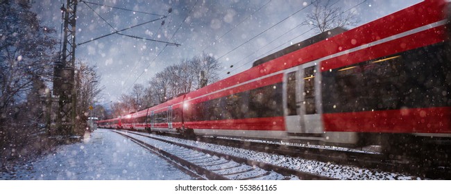 red train speeding in the snow