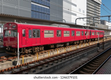 Red train at a station.