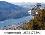 The red tram car of the Goldbelt Mount Roberts Tramway climbs 1800 ft. above Juneau, Alaska